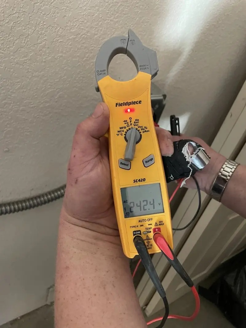 Voltage testing with clamp meter during Generator Installation in Lake Geneva